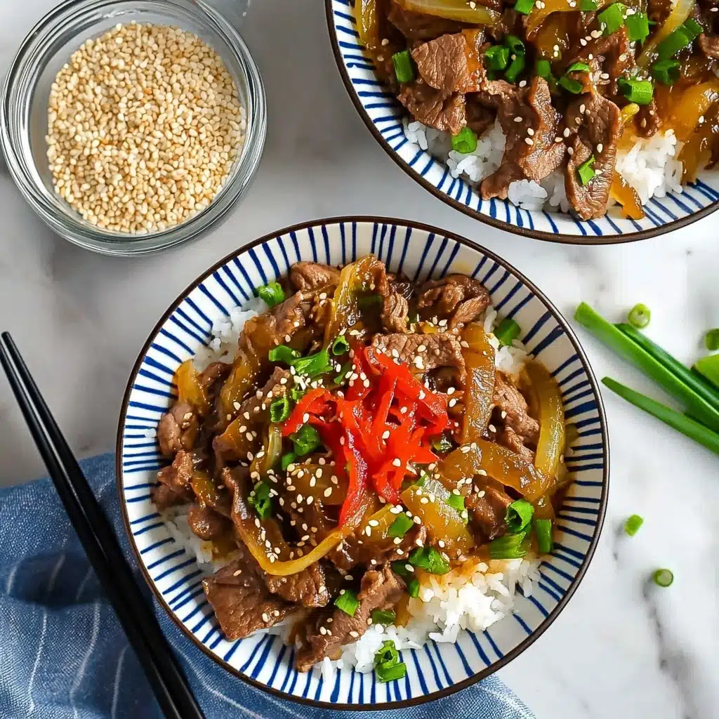 Gyudon Japanese Beef Bowl with Cauliflower Rice, Healthy Gyudon Recipe, Asian Beef Bowl with Low-Carb Cauliflower Rice, Quick Japanese Beef Bowls, Easy Gyudon with Garnishes Two bowls with a blue and white stripe pattern hold a layered dish on a white marbled surface. The bottom layer is white rice, topped with thin brown slices of cooked beef mixed with yellow cooked onions. On top, there are bright green chopped scallions and small white sesame seeds sprinkled, along with a small pile of thin, red pickled slices placed in the center. Black chopsticks with gold details rest on the bowls. Next to the bowls is a white pot containing more of the beef and onions mixture, and a small glass bowl filled with white sesame seeds sits nearby.