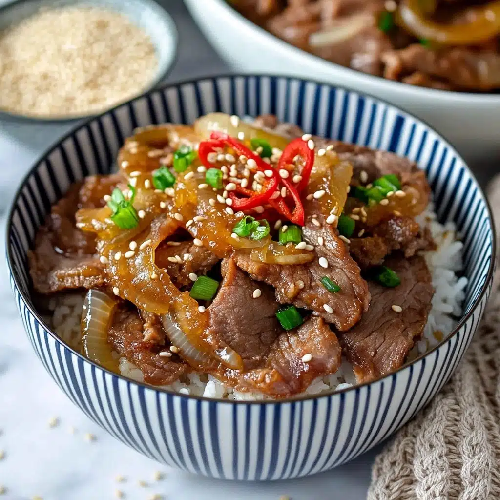 Gyudon Japanese Beef Bowl with Cauliflower Rice, Healthy Gyudon Recipe, Asian Beef Bowl with Low-Carb Cauliflower Rice, Quick Japanese Beef Bowls, Easy Gyudon with Garnishes A white bowl with blue vertical stripes holds a layered dish with white rice at the bottom, topped with cooked brown slices of meat and yellow cooked onions. The meat and onions are garnished with small green onion pieces, white sesame seeds, and thin red pickled strips placed on top. In the soft-focused background, more bowls with the same dish and part of a tray of meat and onions are visible on a white marbled surface. A small bowl of sesame seeds and a beige knitted cloth are near the bowl.