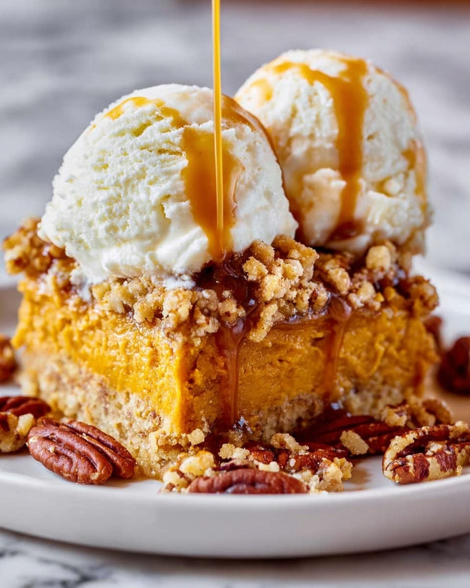 A close-up of a dessert with two layers: the bottom layer is a dense, golden brown cake with visible pieces of nuts giving it a crumbly texture, and the top layer is a smooth, creamy scoop of vanilla ice cream. Thick, glossy caramel sauce is dripping down from the ice cream over the cake, adding a rich amber color that contrasts with the pale cream. The dessert sits on a white plate, and small nut pieces are scattered around the base on a white marbled surface. Photo taken with an iphone --ar 4:5 --v 7