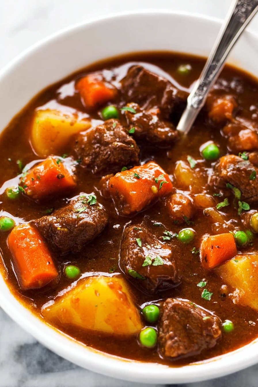 This image shows a thick brown stew filled with several pieces of tender beef, bright orange carrot chunks, and a few green peas scattered throughout. The stew has a rich, smooth, and slightly glossy sauce that coats the meat and vegetables evenly. A large metal ladle in the center lifts a portion of the stew, highlighting the chunky texture of the ingredients and the thick, savory gravy dripping slowly. The background is a white marbled surface. photo taken with an iphone --ar 2:3 --v 7 - Slow Cooker Beef Stew, hearty beef stew, easy beef stew recipe, comfort food beef stew, slow cooker dinner