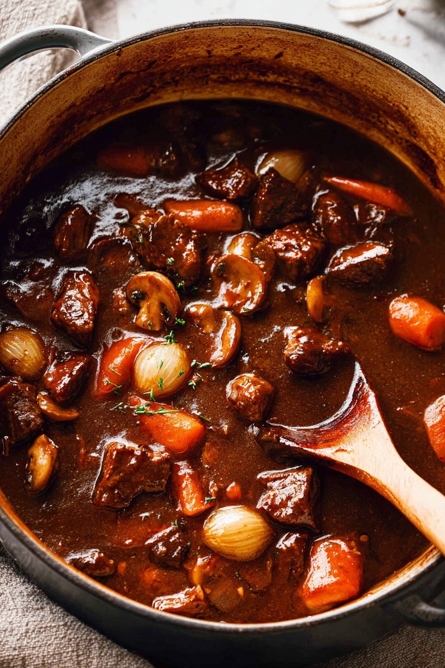 A large pot filled with a thick, dark brown stew containing visible chunks of browned meat, orange carrot slices, small whole pearl onions, and mushrooms, all coated in a shiny sauce. The stew is being stirred by a wooden spoon positioned on the right side inside the pot. The pot sits on a white marbled surface with a textured background of light fabric. Photo taken with an iphone --ar 2:3 --v 7 - Beef Bourguignon, Beef Burgundy, Classic Beef Stew, French Beef Stew, Hearty Red Wine Beef Dish