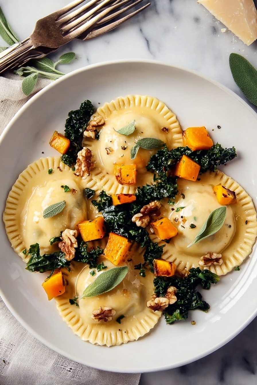 Two white plates on a white marbled surface each hold three large ravioli pieces. The ravioli are light yellow with crimped edges, placed over dark green cooked kale leaves. Small, bright orange cubes of roasted squash are scattered on top along with a few light brown walnut pieces. Fresh green sage leaves and tiny thyme leaves are sprinkled over the dish. One plate has a black-handled fork and a silver knife resting on it, while another fork with a beige handle lies on the surface nearby. To the left, a small wooden dish holds extra walnuts, next to two glass jars—one with olive oil and one with white vinegar. Fresh sage sprigs and a blue cloth napkin are around the plates. photo taken with an iphone --ar 2:3 --v 7 - Butternut Squash Ravioli with Sage-Walnut Filling and White Wine Sage Sauce, autumn ravioli recipe, homemade pumpkin ravioli, sage and walnut pasta, cozy fall pasta dish