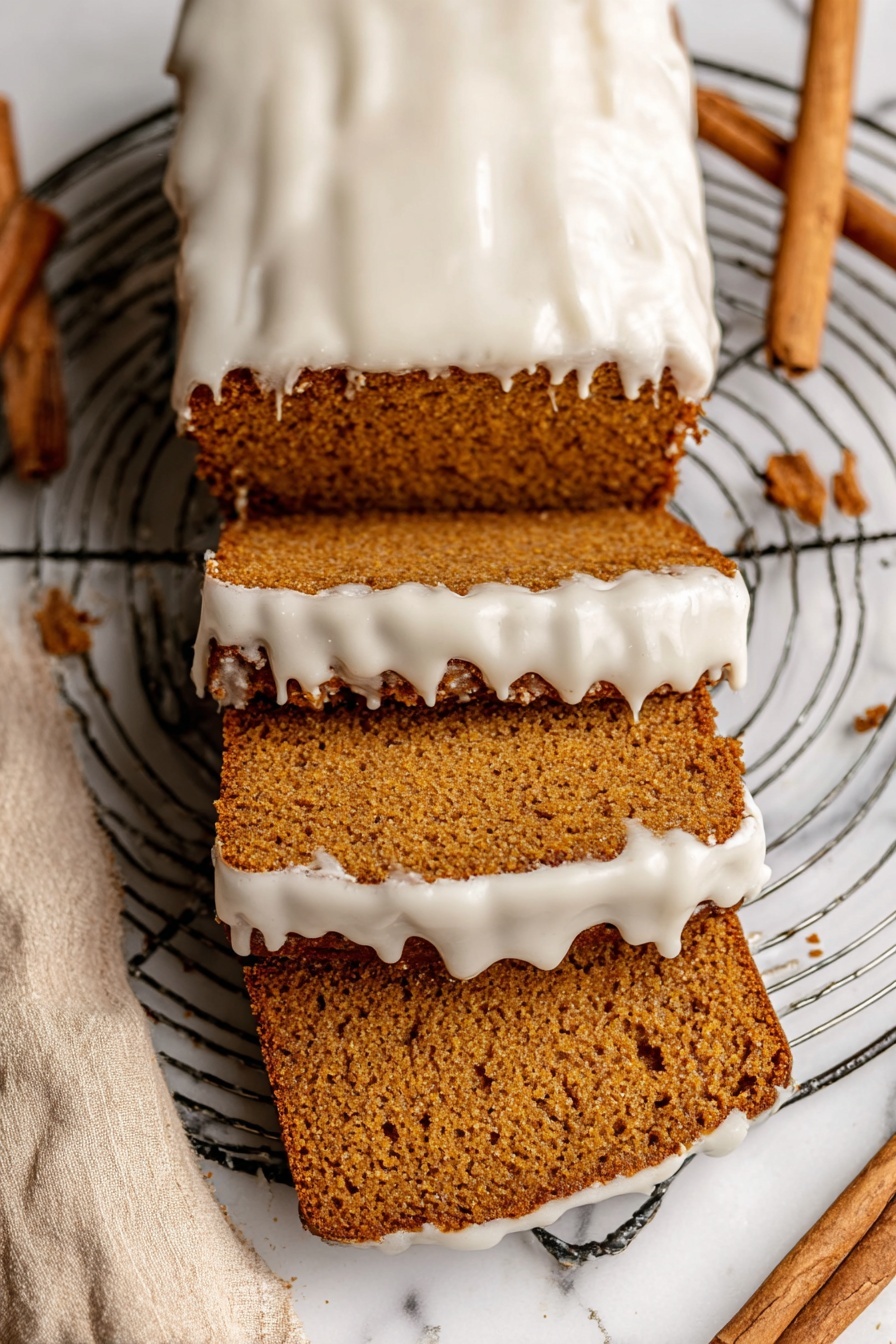 The image shows a loaf of brown cake with three slice pieces cut from it, stacked and spread out below the rest of the loaf. The top of the cake and the edges of the slices have a thick layer of white icing that looks smooth but slightly melted, dripping down the sides. The cake has a dense, moist texture with visible small holes inside. The loaf rests on a round metal wire cooling rack placed on a white marbled surface with a beige cloth and cinnamon sticks nearby. Photo taken with an iphone --ar 2:3 --v 7 - Healthy Pumpkin Bread with Maple Glaze, pumpkin bread recipe, healthy pumpkin loaf, wholesome pumpkin bread, maple glaze pumpkin bread