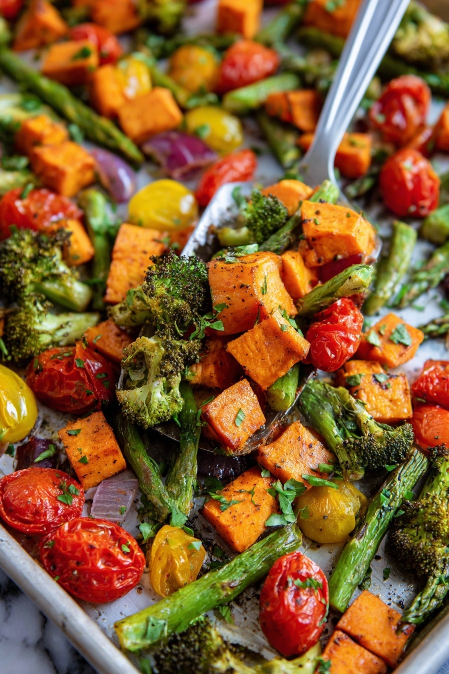 This image shows a close-up of a tray filled with roasted vegetables in layers. The first layer has bright orange sweet potato chunks with a slightly crispy texture. The second layer is made up of green asparagus spears and small broccoli pieces with roasted edges. The third layer consists of red and yellow cherry tomatoes, some whole and some cut in half showing their juicy inside. The vegetables are mixed together with small green herb leaves sprinkled on top. The background surface is a white marbled texture. A metal spatula is lifting a mix of these vegetables in the center of the image, with a woman's hand partly visible on the side. photo taken with an iphone --ar 2:3 --v 7 - Sheet Pan Roasted Vegetables, healthy roasted vegetables, easy vegetable side dish, colorful veggie medley, quick vegetable roasting