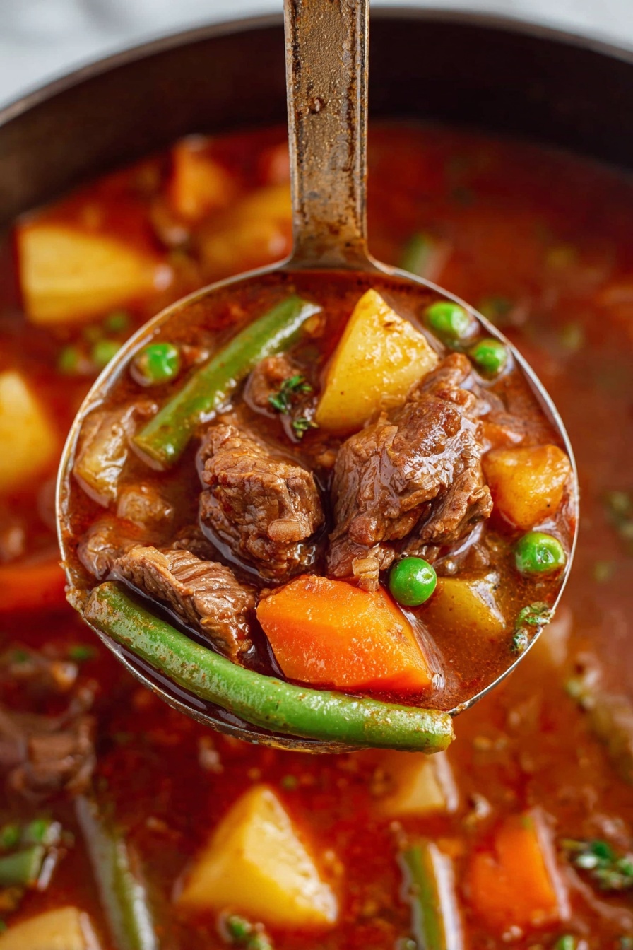 A close-up view of a ladle lifting a rich beef stew filled with soft brown chunks of beef, bright orange carrot pieces, yellow potato cubes, green beans, and green peas all mixed in a thick, deep reddish-brown broth. The background shows more of the stew with similar colorful vegetables and beef pieces visible. The ladle handle stands upright, emphasizing the hearty ingredients and texture of the dish. The scene is set on a white marbled surface. Photo taken with an iphone --ar 2:3 --v 7 - Vegetable Beef Stew, hearty beef stew recipe, easy beef stew, homemade beef stew, comforting vegetable stew