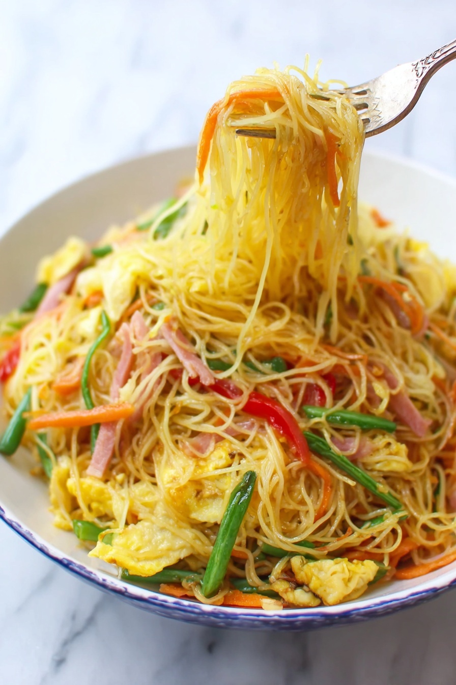 A white bowl filled with thin yellow noodles mixed with bright orange carrot strips, light green beans, red bell pepper slices, and small pieces of scrambled egg, all stirred together with thin strips of ham that have a light pink color. A fork lifts a bundle of noodles from the bowl, showing the textured and slightly oily surface of the noodles. The background is a white marbled surface. photo taken with an iphone --ar 2:3 --v 7 - Singapore Rice Noodles, Singapore Rice Noodles recipe, Asian noodle stir-fry, Thai-style rice noodle dish, flavorful Chinese stir-fry