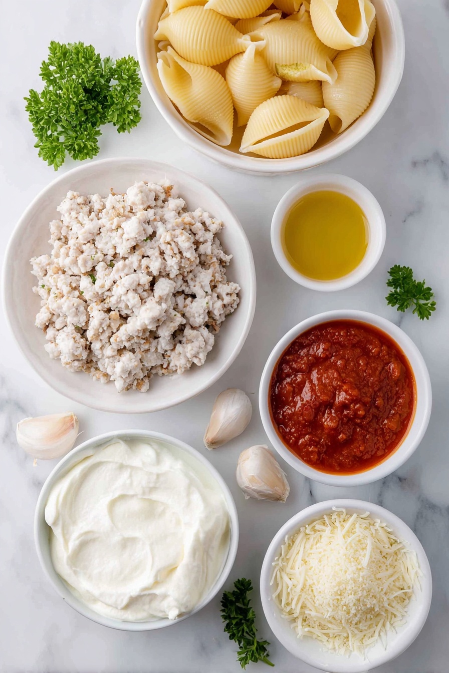 Flat lay of jumbo pasta shells arranged next to a small white bowl of olive oil, a mound of ground chicken pieces seasoned with dried Italian herbs and salt, a large white ceramic bowl filled with creamy whole milk ricotta cheese, a small white bowl holding shredded mozzarella cheese, another small white bowl with grated Parmesan cheese, one whole uncracked large egg with a clean shell, four peeled garlic cloves, a small white bowl containing vibrant red marinara sauce, a small white bowl of light golden Panko breadcrumbs, and a few fresh sprigs of chopped parsley scattered nearby, all placed on a clean white marble surface, soft natural light, photo taken with an iPhone, professional food photography style, fresh ingredients, white ceramic bowls, no bottles, no duplicates, no utensils, no packaging --ar 2:3 --v 7 --p m7354615311229779997 - Chicken Parmesan Stuffed Shells, cheesy Italian stuffed pasta, baked chicken and cheese shells, easy chicken pasta dinner, crowd-pleasing stuffed shells