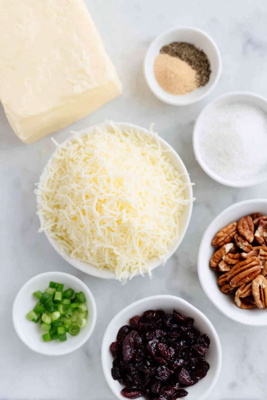 Flat lay of a block of full-fat cream cheese softened, a small heap of shredded sharp white cheddar cheese, a few sprigs of chopped fresh green onions, a small white bowl of light brown sugar, a small white bowl of garlic powder, a small white bowl of fine salt, a small white bowl of ground black pepper, a small white bowl of finely chopped dried cranberries, and a small white bowl of finely chopped pecans, all arranged in perfect symmetry on a clean white marble surface, soft natural light, photo taken with an iPhone, professional food photography style, fresh ingredients, white ceramic bowls, no bottles, no duplicates, no utensils, no packaging --ar 2:3 --v 7 --p m7354615311229779997 - Cranberry Pecan Cheese Ball, holiday appetizer, festive cheese ball, easy cheese ball recipe, party appetizer ideas