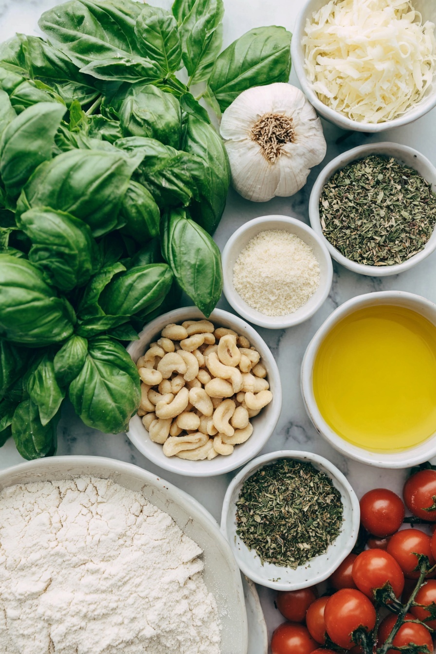 Flat lay of fresh bright green basil leaves and a few sprigs of mixed leafy herbs, a small pile of raw Australian macadamia nuts, two whole uncracked garlic cloves, a small white bowl of golden extra virgin olive oil, a small white bowl of nutritional yeast flakes, a small white bowl of lemon juice, a small white bowl of coarse sea salt, a mound of smooth all-purpose flour, a small white bowl of warm dairy-free milk, a chunk of soft vegan butter, a small white bowl of granulated sugar, a small white bowl of instant dry yeast granules, a small white bowl of mixed dried herbs, a scattering of whole and crushed raw macadamia nuts, and a handful of glossy red cherry tomatoes, all arranged with perfect symmetry on a clean white ceramic plate and in simple white ceramic bowls, placed on a clean white marble surface, soft natural light, photo taken with an iPhone, professional food photography style, fresh ingredients, white ceramic bowls, no bottles, no duplicates, no utensils, no packaging --ar 2:3 --v 7 --p m7354615311229779997 - Vegan Pesto Bread Wreath, vegan bread recipes, homemade pesto bread, festive bread wreath, plant-based appetizer ideas