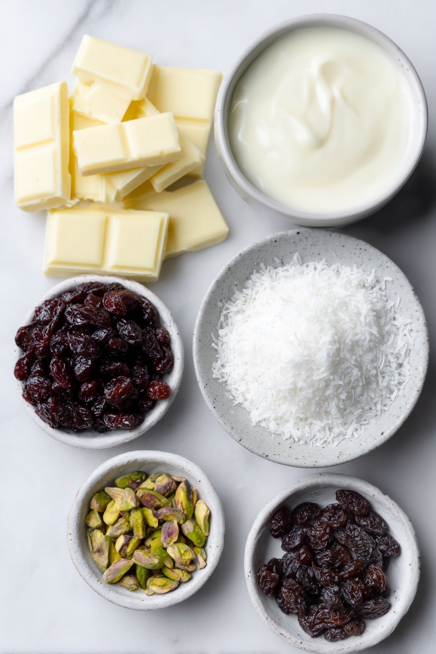 Flat lay of a small pile of chopped white chocolate pieces, a small white ceramic bowl filled with thickened cream, a tiny white bowl holding glossy vanilla bean paste, a small white bowl containing chopped dried cranberries, a small white bowl with chopped pistachios, and a shallow white ceramic dish with fine desiccated coconut arranged neatly beside them, all ingredients fresh and natural, placed on a clean white marble surface, soft natural light, photo taken with an iPhone, professional food photography style, fresh ingredients, white ceramic bowls, no bottles, no duplicates, no utensils, no packaging --ar 2:3 --v 7 --p m7354615311229779997 - White Chocolate Cranberry Pistachio Truffles, festive holiday treats, no-bake chocolate truffles, easy Christmas candies, homemade holiday desserts