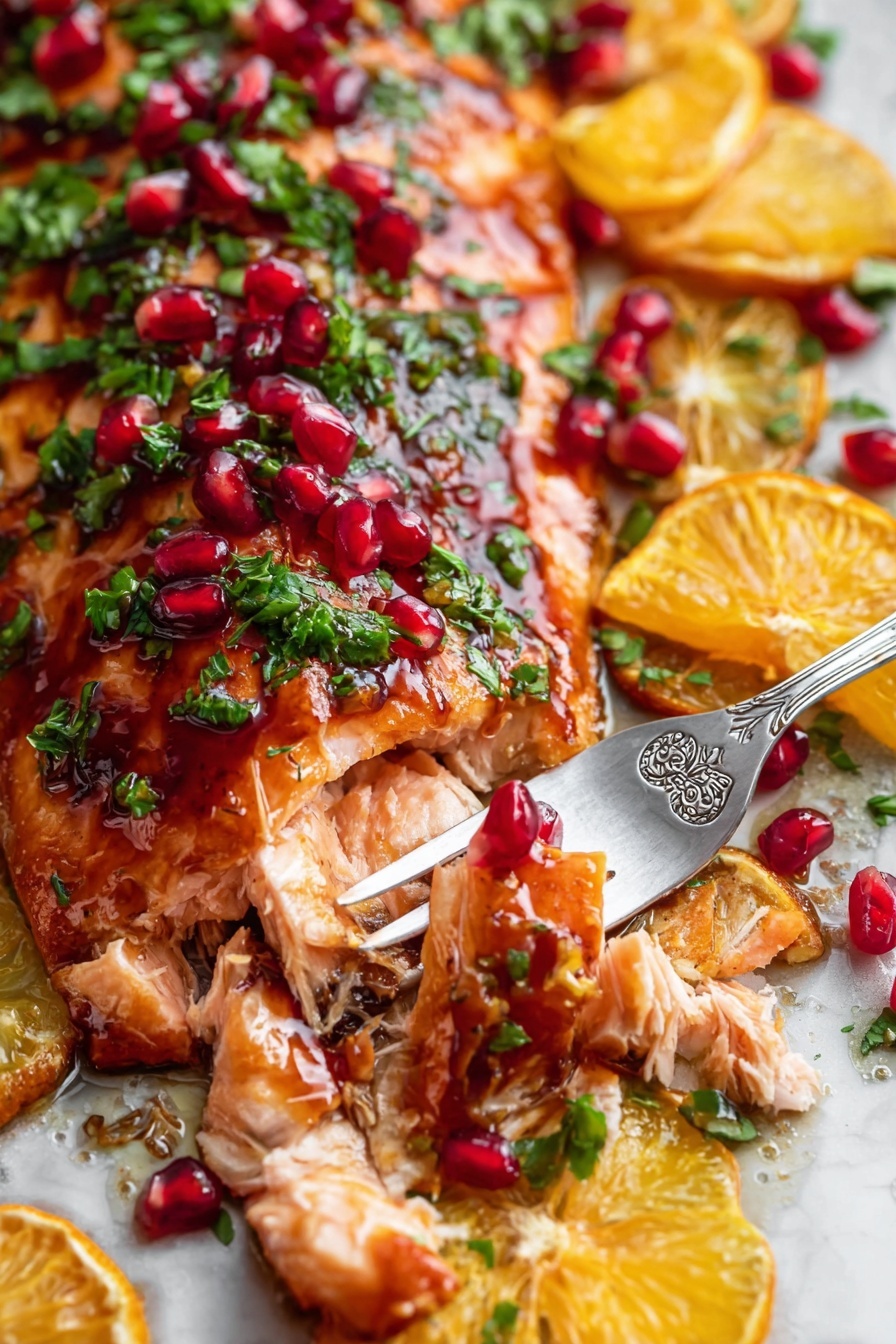 The image shows a close-up of a cooked salmon fillet with a shiny, reddish-brown glaze. On top of the salmon, there are small green herb pieces, bright red pomegranate seeds, and orange slices cut into wedges. The salmon is flaking apart slightly where a silver fork with floral designs holds a piece of the fish. All the elements are arranged over a white marbled surface. The colors are rich and vibrant, with the orange slices and pomegranate seeds standing out against the green herbs and the warm, cooked salmon. Photo taken with an iphone --ar 2:3 --v 7 - Pomegranate Orange Glazed Salmon, citrus salmon recipe, healthy seafood dinner, easy fish recipes, flavorful salmon glaze