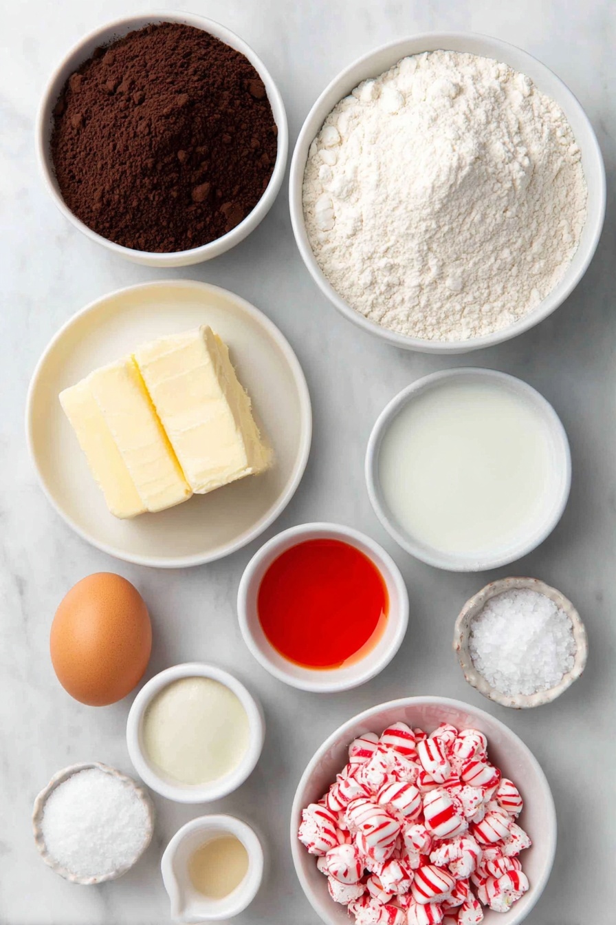 Flat lay of a small mound of all-purpose flour, a small white ceramic bowl of unsweetened cocoa powder, a small white ceramic bowl of baking powder, a small white ceramic bowl of baking soda, a small white ceramic bowl of salt, a half cup of softened unsalted butter in a white ceramic dish, a small pile of granulated sugar on a white ceramic plate, one large whole egg with a clean shell, a small white ceramic bowl of vanilla extract, a small white ceramic bowl containing vibrant red gel food coloring, a small white ceramic bowl of buttermilk, a neat cluster of unwrapped red and silver peppermint candy kisses, and a small white ceramic bowl filled with crushed red and white peppermint candies, all arranged with perfect symmetry and realistic proportions, placed on a clean white marble surface, soft natural light, photo taken with an iPhone, professional food photography style, fresh ingredients, white ceramic bowls, no bottles, no duplicates, no utensils, no packaging --ar 2:3 --v 7 --p m7354615311229779997 - Red Velvet Peppermint Cookies, festive holiday cookies, peppermint red velvet cookies, Christmas cookie recipes, easy holiday treats