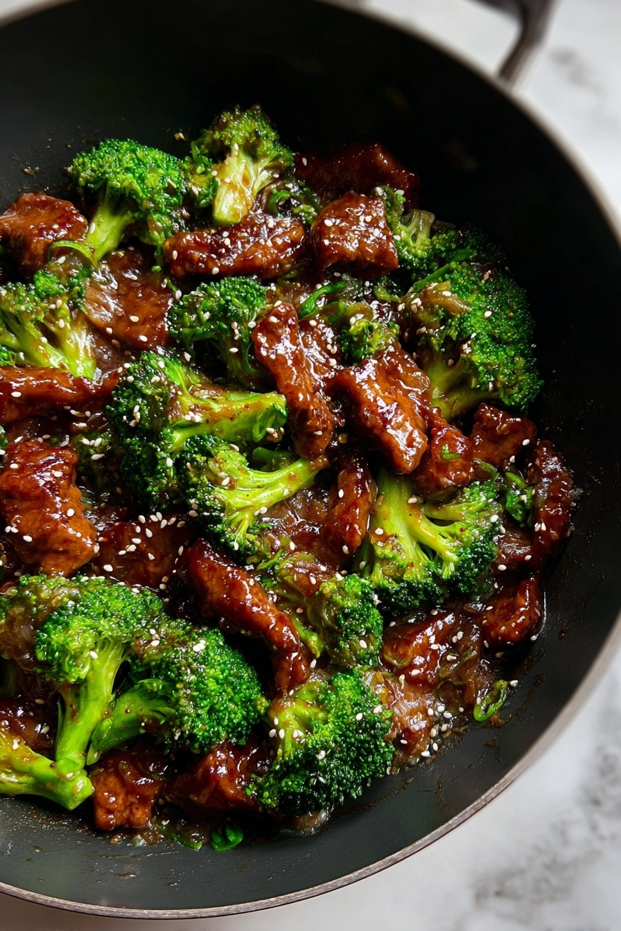 The dish shows about two layers mixed together in a black wok on a white marbled surface. The first layer is bright green broccoli florets that look fresh and slightly glossy. The second layer consists of shiny, brown pieces of meat coated in a thick sauce. Light-colored sesame seeds are sprinkled evenly on top, adding small spots of contrast. The sauce gives the meat a wet and glossy texture, while the broccoli adds a rough, natural look. The whole dish looks warm and tasty, with a good mix of colors and textures. Photo taken with an iphone --ar 2:3 --v 7 - Chinese Beef with Garlic Sauce, Chinese Beef stir-fry, Garlic sauce beef recipe, easy Chinese beef recipes, homemade Chinese takeout beef