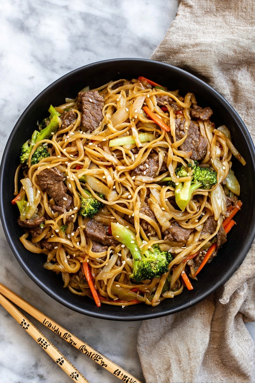 A black bowl filled with stir-fried noodles mixed with pieces of beef, bright green broccoli florets, thin orange carrot strips, and light brown cooked onions, all coated in a light sauce giving a slight shine; the noodles are long and a pale tan color, twisting through the vegetables and meat, garnished with small white sesame seeds. The bowl sits on a white marbled surface next to a pair of light wooden chopsticks decorated with simple patterns, and a beige cloth napkin is casually placed nearby. photo taken with an iphone --ar 2:3 --v 7 - Beef Lo Mein, Chinese beef stir-fry, quick lo mein noodles, easy Chinese dinner, savory beef noodle dish